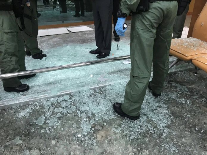 Police and military officers collect evidence Monday at the scene of bombing at Phramongkutklao Hospital.