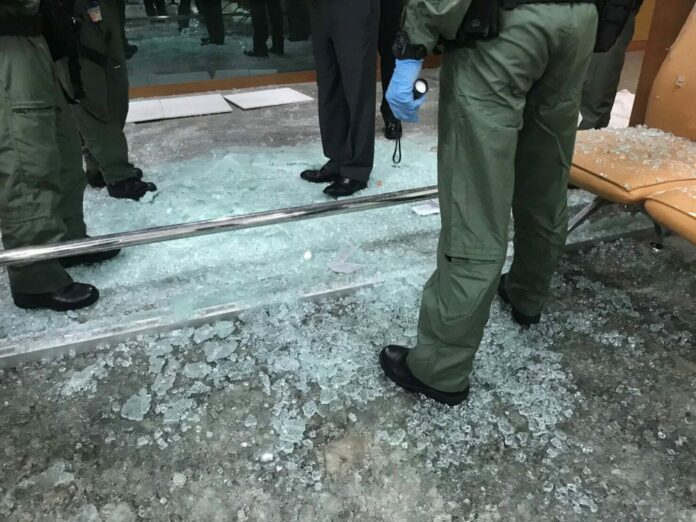 Police and military officers collect evidence Monday at the scene of bombing at Phramongkutklao Hospital.