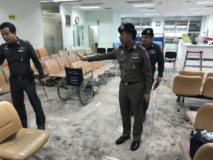 Police and military officers collect evidence Monday at the scene of bombing at Phramongkutklao Hospital.