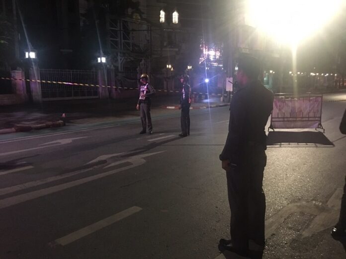 Policemen stand guard Monday by the scene of an explosion at Sanam Luang.