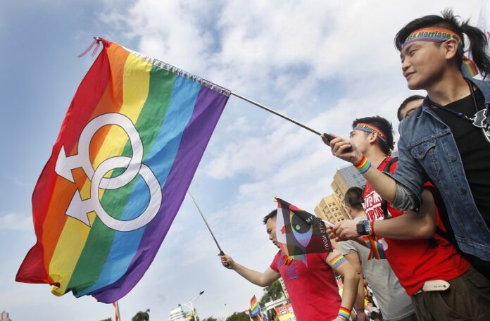 Supporters of LGBT and human rights wave rainbow flags during a rally supporting a proposal to allow same-sex marriage last December in Taipei, Taiwan on the World Human Rights Day. Photo: Chiang Ying-ying / Associated Press