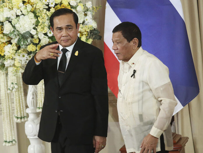 Prime Minister Prayuth Chan-ocha, at left, and Philippine President Rodrigo Duterte, at right, leave a joint news conference on March 21, 2017, in Bangkok. Photo: Sakchai Lalit / Associated Press