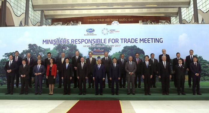Vietnamese Prime Minister Nguyen Xuan Phuc, center in front row, ministers and officials pose for a group photo, at the Asia-Pacific Economic Cooperation (APEC) Trade ministerial meeting Saturday in Hanoi, Vietnam. Photo: Hau Dinh / Associated Press