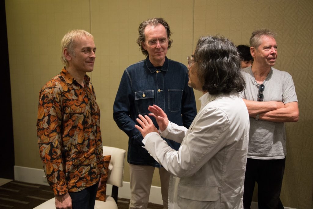 Karl Hyde, at left, and Rick Smith, at center, speak with architect Duangrit Bunnag, who organized the Super Summer Sound Festival. Photo: Thapphawhut Parinyapariwat