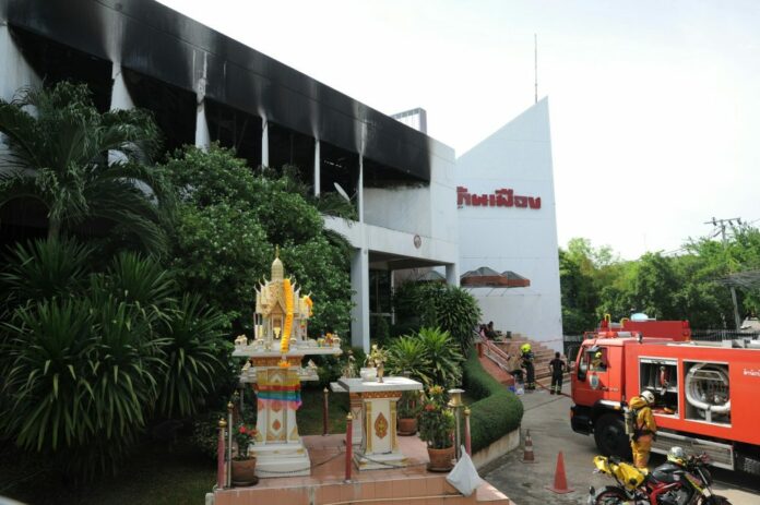Upper-floor fire damage is visible Monday at the Banmuang news agency’s building Bangkok.