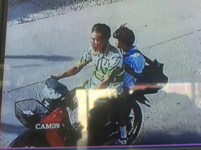 A still image from security footage said to show Wichai Chotisena, 58, with an 11-year-old schoolgirl on his motorcycle.