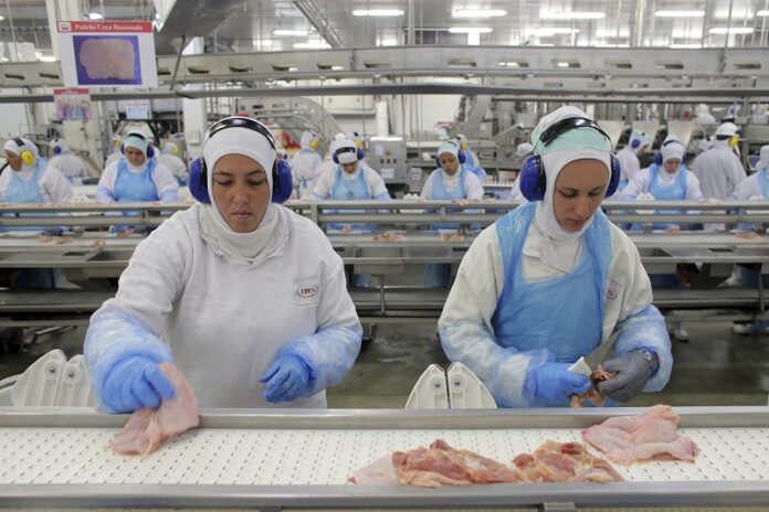 Workers prep poultry at the meatpacking company JBS in March in Lapa, Brazil. Photo: Eraldo Peres / Associated Press