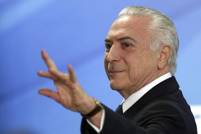 Brazil's President Michel Temer waves as he exits after attending a ceremony Monday at the Planalto Presidential Palace, in Brasilia. Photo: Eraldo Peres / Associated Press