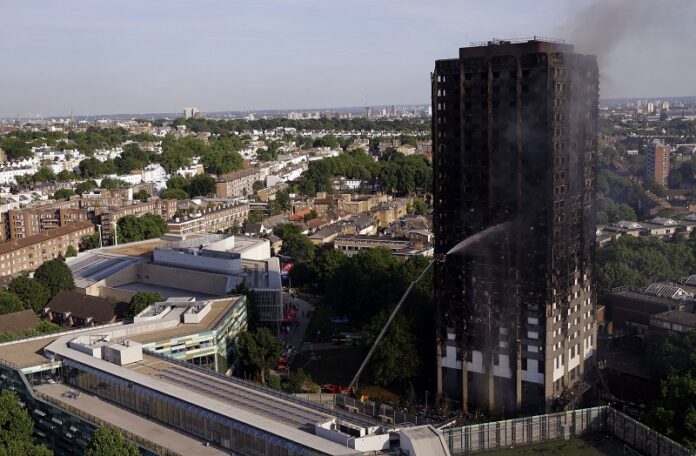 Firefighters work at the scene after a deadly blaze at a high rise apartment block Wednesday in London. Photo: Alastair Grant / Associated Press