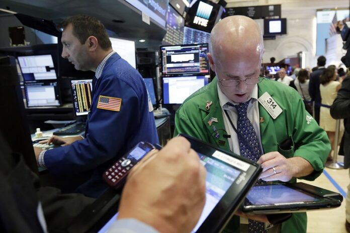 Trader Kevin Walsh, right, works in 2017 on the floor of the New York Stock Exchange. Photo: Richard Drew / Associated Press