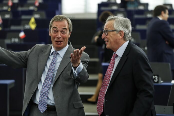 Britain's former UKIP leader Nigel Farage, left, talks with European Commission President Jean-Claude Juncker during a European Parliament plenary session in Strasbourg, France, on May 17. Photo: Jean-Francois Badias / Associated Press