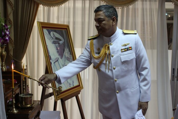 Pongthep Nhuthep lights a candle to honor King Bhumibol during a state ceremony at the Bangkok Navy Base on May 7, 2013. Image: Royal Thai Navy