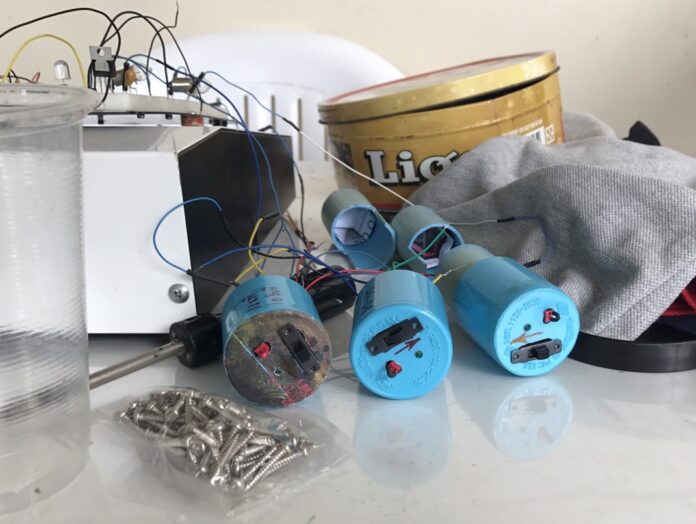In this photo released by the military, soldiers present what they describe as bomb-making equipment at the residence of hospital bombing suspect Wattana Pumares.