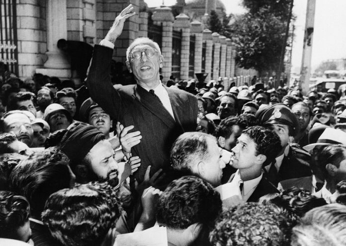 Sept. 27, 1951 file photo, Prime Minister Mohammed Mosaddegh rides on the shoulders of cheering crowds in reiterating his oil nationalisation views to his supporters. Photo: Associated Press