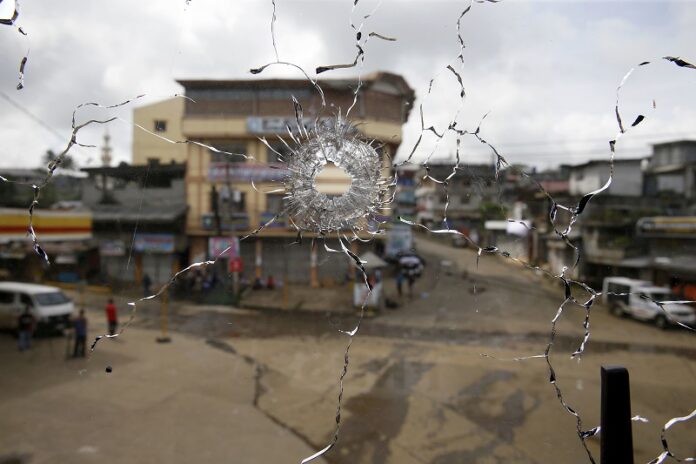 A bullet hole is seen on a window glass in a building at the site of an earlier gun battle between government forces and Muslim militants in June in Marawi. Photo: Bullit Marquez / Associated Press