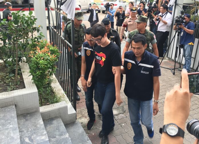 Police escort activist Rangsiman Rome to the military tribunal in Bangkok on Monday