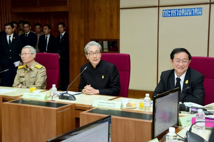 Deputy Prime Minister Somkid Jatusripitak, seated at middle, and Transport Minister Akhom Termpittayapaisit, at right, meet Monday at the Ministry of Transport in Bangkok.