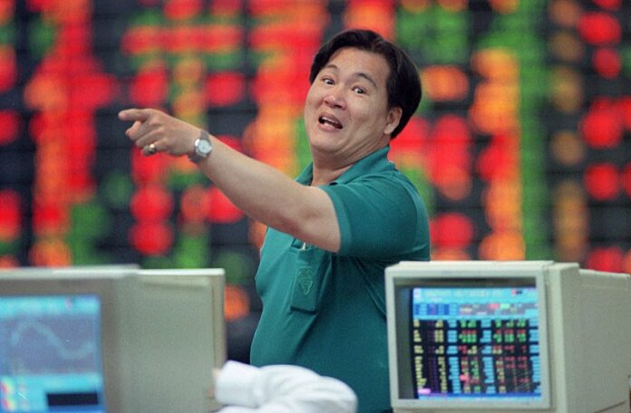A local investor reacts to falling prices in 1997 at the stock exchange in Bangkok, Thailand. Photo: Thaksina Khaikaew / Associated Press
