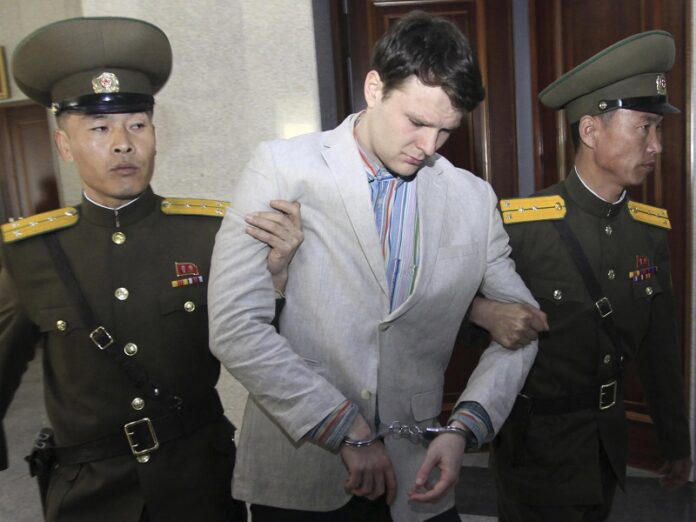 American student Otto Warmbier, center, is escorted at the Supreme Court in 2016 in Pyongyang, North Korea. Photo: Jon Chol Jin / Associated Press