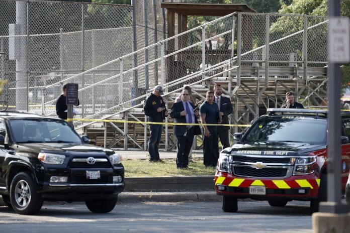 Law enforcement officers investigate a shooting near a baseball field in Alexandria, Virginia on Wednesday. Photo: Alex Brandon / Associated Press