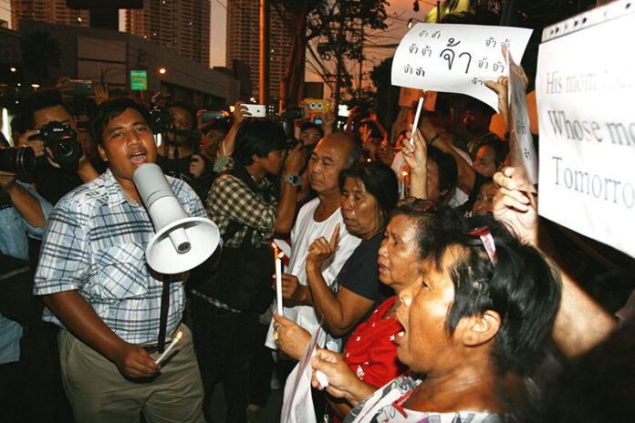 Sirawith Serithiwat, whose mother was charged with lese majeste over a single word in an online chat, leads a protest May 7, 2016, for fair treatment of those who face similar charges in front of a police station in Bangkok.