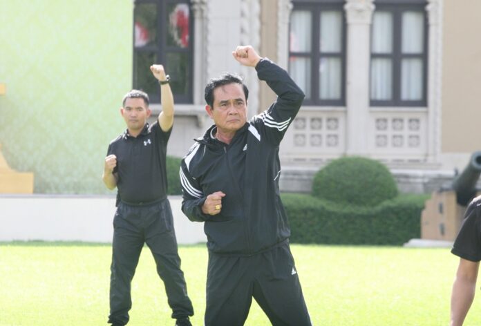 Junta chairman Prayuth Chan-ocha performs his weekly exercises during Workout Wednesday in front of Government House.