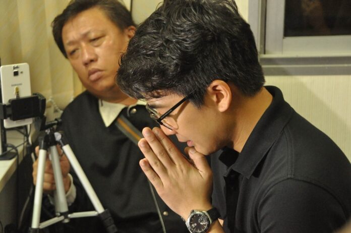 Acharanat “Nott” Ariyaritwikol apologizes to the media on Nov. 8, 2016, at a police station in Bangkok.