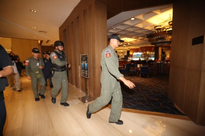 Bomb squad officers arrive at Centara Grand Hotel on Saturday