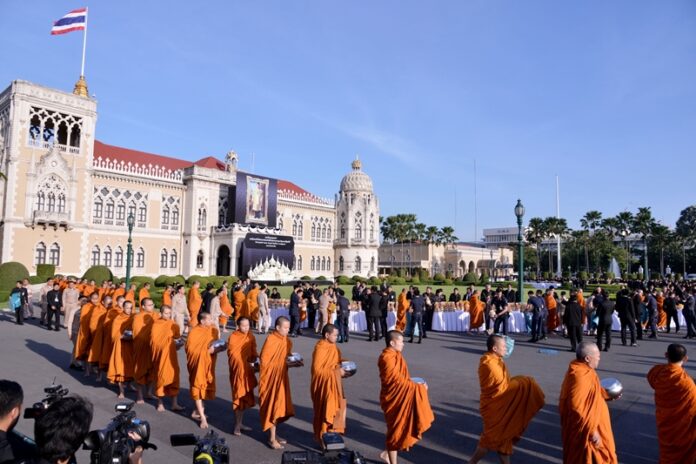 Monks gather alms at Government House on Dec. 1, 2016, during a Buddhist ceremomy to make merit for the late King Bhumibol.