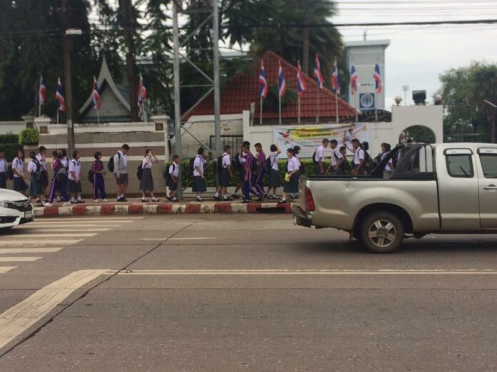 Students line up in front of Udonpittayanukoon School in Udon Thani on Monday.