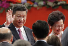 China’s Xi Promises Market Opening as Import Fair Begins Chinese President Xi Jinping, left, and Hong Kong's new Chief Executive Carrie Lam leave after administered the oath for a five-year term in office at the Hong Kong Convention and Exhibition Center in 2017. Photo: Kin Cheung/ AP.