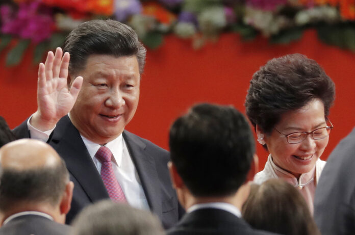 Chinese President Xi Jinping, left, and Hong Kong's new Chief Executive Carrie Lam leave after administered the oath for a five-year term in office at the Hong Kong Convention and Exhibition Center in 2017. Photo: Kin Cheung/ AP.