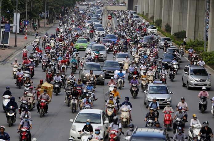 In this June 21, 2017, photo, motorbikes and cars fight for space on a street in Hanoi, Vietnam. Photo: Tran Van Minh / Associated Press