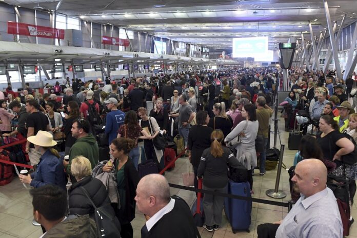 People crowd a terminal at Sydney's domestic airport as passengers are subjected to increased security, Monday in Sydney, Australia. Photo: Dean Lewins / Associated Press