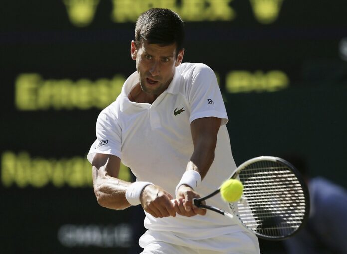 Serbia's Novak Djokovic returns to Latvia's Ernests Gulbis during their Men's Singles Match on day six at the Wimbledon Tennis Championships, Saturday in London. Photo: Tim Ireland / Associated Press