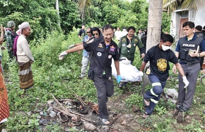 Rescue workers carry the body of Suding Mamah, 29, after he was shot dead Wednesday during a raid by military officers in Pattani province.