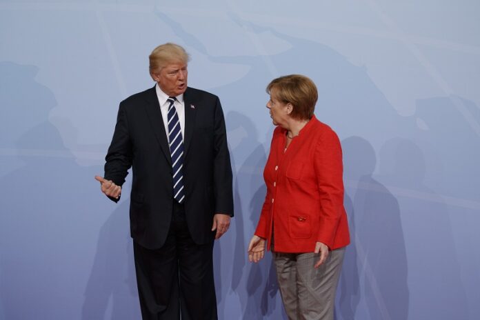 President Donald Trump is greeted by German Chancellor Angela Merkel after arriving at the G20 Summit, Friday in Hamburg, Germany. Photo: Evan Vucci / Associated Press