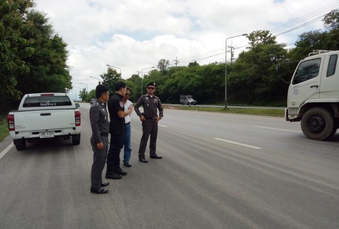 Police officers at the site where an 18-wheeler truck hit a car at police checkpoint in Lampang province on Monday