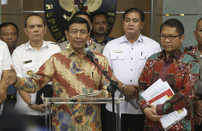 Indonesian officials gesture at a July 12 news conference announcing a presidential decree to amend an existing law regulating mass organization in a bid to rein in radical groups. Photo: Dita Alangkara / Associated Press