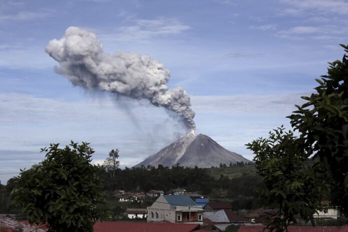 Mount Sinabung spews volcanic ash into the air, as seen from Berastagi, North Sumatra, Indonesia. Photo: Binsar Bakkara / Associated Press