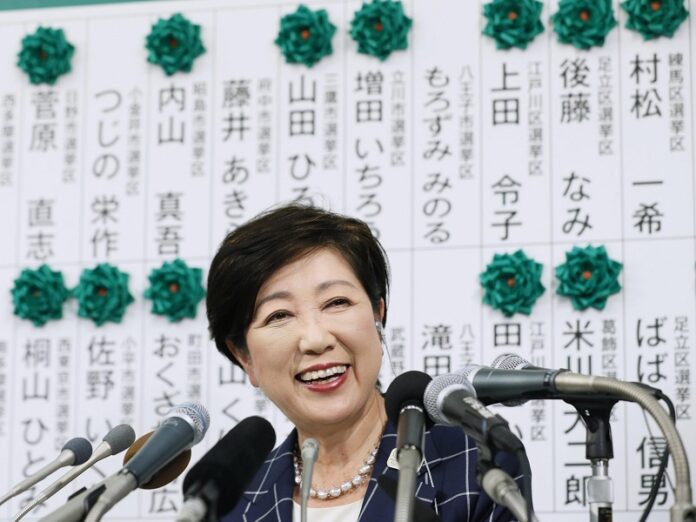 Tokyo Gov. Yuriko Koike smiles as she learns many candidates of her new party, Tomin First no Kai, or Tokyoites First Party, are being elected while waiting for the result of Sunday's city assembly election in Tokyo. Photo: Suo Takekuma / Associated Press