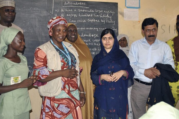 Pakistani activist Malala Yousafzai, centre right, stands Tuesday during a visit to a school in Maiduguri Nigeria. Photo: Jossy Ola / Associated Press