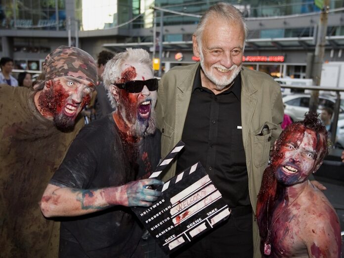 Director George Romero poses with some fans dressed as zombies after accepting a special award during the Toronto International Film Festival in 2009 in Toronto. Photo: Darren Calabrese / Associated Press