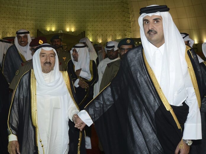 Kuwait's Emir Sheikh Sabah Al Ahmad Al Sabah, left, holds the hand of Qatar's Emir Sheikh Tamim bin Hamad Al Thani last month in Doha, Qatar. Photo: Associated Press