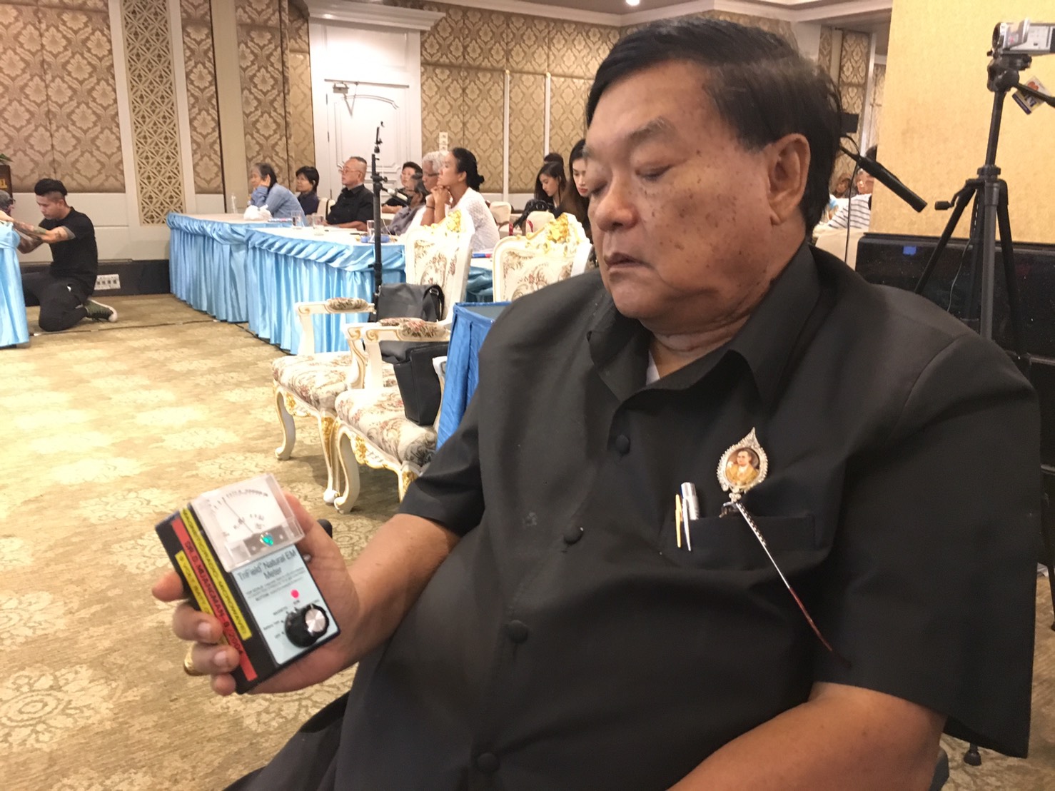 Dephanom Muangman, a Harvard-trained, former heart surgeon, demonstrates the use of his EMF meter to detect the proximity of extraterrestrials.