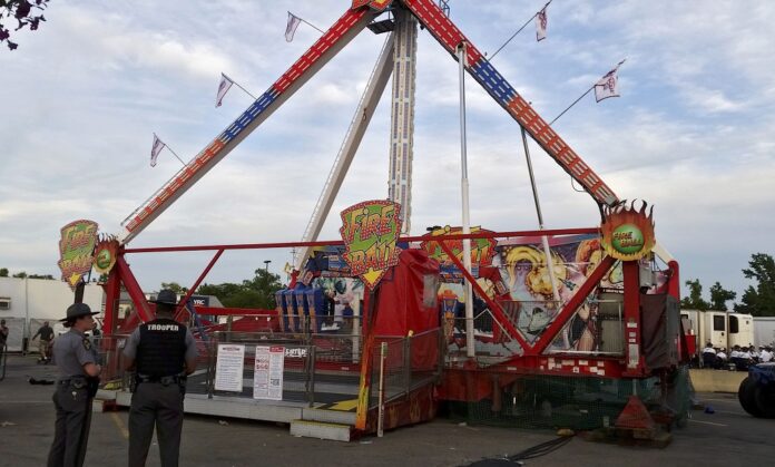 Authorities stand near the Fire Ball amusement ride after the ride malfunctioned injuring several at the Ohio State Fair, Wednesday, July 26, 2017, in Columbus, Ohio. Some of the victims were thrown from the ride when it malfunctioned Wednesday night, said Columbus Fire Battalion Chief Steve Martin. Photo: Jim Woods / The Columbus Dispatch via Associated Press
