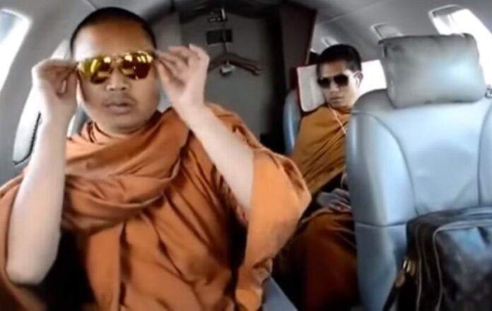 An image from video which emerged in 2013 shows Wirapol Sukphol or Luang Puu Nen Kham on board a private jet.