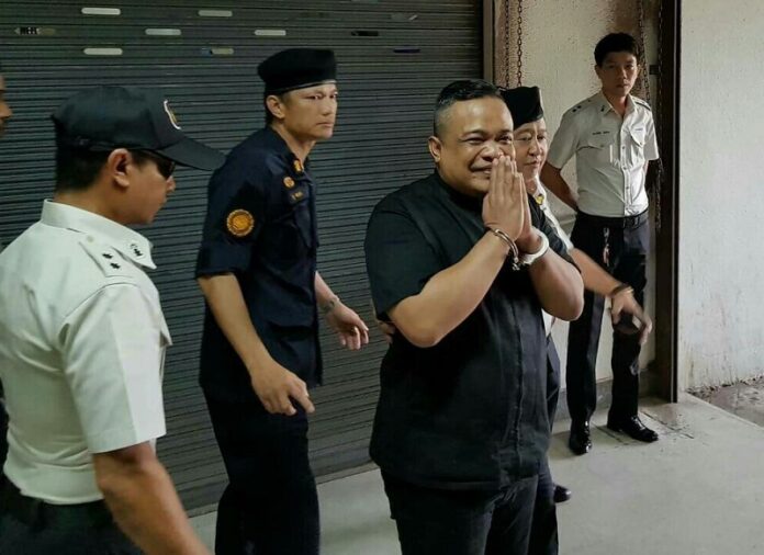 Redshirt leader Jatuporn Prompan is taken Thursday from the Criminal Court to prison.