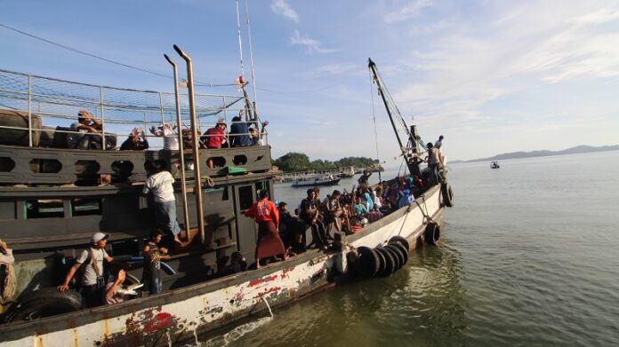 Migrant workers are aboard a vessel Monday heading from Ranong province to Myanmar.
