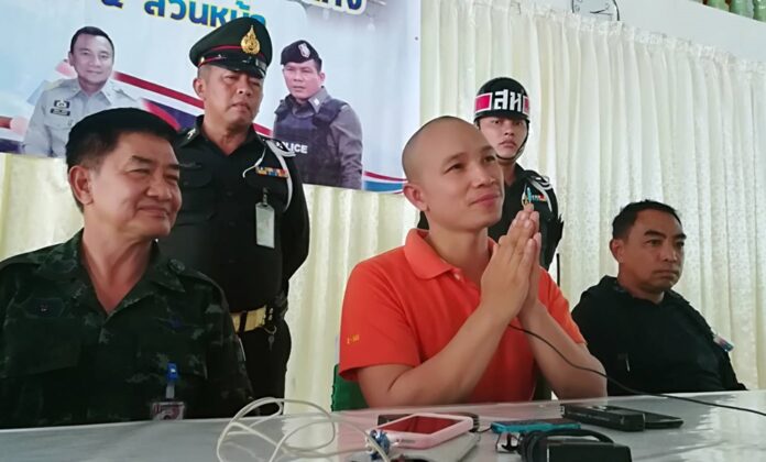 Preecha Intarangsee “wai” in apology at an army-organized news conference Wednesday